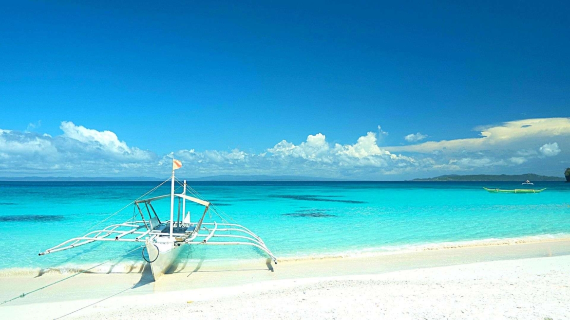 A beach with a local boat